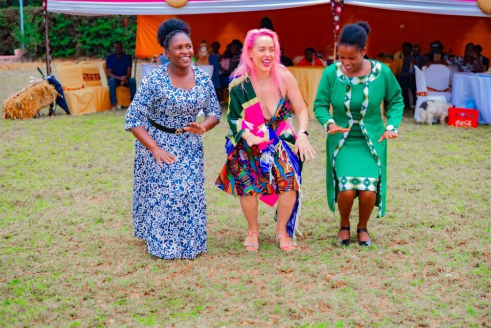 A Mambo Leo founder dancing with members of a Kenyan women's group